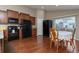Eat-in kitchen features granite countertops, a black appliance package, and hardwood floors at 5131 Delphinium Cir, Brighton, CO 80601