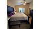 Spacious main bedroom featuring a ceiling fan and large window at 5131 Delphinium Cir, Brighton, CO 80601