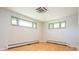Clean and bright bedroom with hardwood floors and multiple windows at 6600 E 4Th Ave, Denver, CO 80220