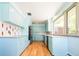 Stylish kitchen with blue cabinets, modern appliances, and plenty of counter space at 6600 E 4Th Ave, Denver, CO 80220