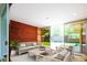 Cozy sunroom with comfortable seating, large windows, and access to the backyard at 6600 E 4Th Ave, Denver, CO 80220