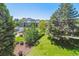 Aerial view of community with mature trees, manicured lawns, pool and other amenities at 7420 E Quincy Ave # 304, Denver, CO 80237