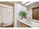 Bathroom with attractive vanity, large mirror, and shower with white curtain at 7420 E Quincy Ave # 304, Denver, CO 80237