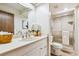 Well-lit bathroom with modern fixtures, a vanity, and a glass-enclosed shower at 7420 E Quincy Ave # 304, Denver, CO 80237