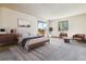 Serene bedroom with a sliding glass door leading to a balcony and well-appointed furniture at 7420 E Quincy Ave # 304, Denver, CO 80237