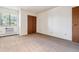 Bright bedroom features neutral carpeting, a window with tree view, and closet for ample storage at 7420 E Quincy Ave # 304, Denver, CO 80237