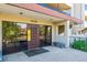 Building entrance featuring glass doors, exterior lighting, and a small bench at 7420 E Quincy Ave # 304, Denver, CO 80237