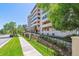 Exterior building shot showing facade, balconies, greenery, and attractive landscaping at 7420 E Quincy Ave # 304, Denver, CO 80237