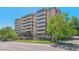 Exterior building shot showing facade, balconies, greenery, and attractive landscaping at 7420 E Quincy Ave # 304, Denver, CO 80237