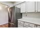 Corner shot of kitchen showcasing stainless steel appliances and sleek white cabinets at 7420 E Quincy Ave # 304, Denver, CO 80237