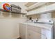 Convenient laundry room complete with full-size washer and dryer and wire shelving at 7420 E Quincy Ave # 304, Denver, CO 80237