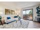 Bright living room with a sliding glass door leading to the balcony and modern decor at 7420 E Quincy Ave # 304, Denver, CO 80237
