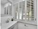 Bright bathroom featuring a large mirror and a white sink with gray cabinet at 755 S Milwaukee St, Denver, CO 80209