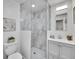 Modern bathroom featuring a glass shower with gray tile and a vanity with white cabinets and a gray countertop at 755 S Milwaukee St, Denver, CO 80209