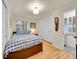 Bright bedroom features a large bed with blue patterned linens, white shutters, and white wardrobe storage at 755 S Milwaukee St, Denver, CO 80209