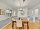 Well-lit dining room featuring a wooden table with four chairs, complemented by modern lighting and neutral decor, perfect for meals at 755 S Milwaukee St, Denver, CO 80209