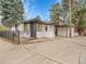 Charming white brick home with a covered carport, black trim, and a well-maintained front yard in a residential area at 755 S Milwaukee St, Denver, CO 80209