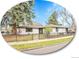 Charming single-story home with a black iron fence, lush lawn, mature trees, and a well-maintained garden at 755 S Milwaukee St, Denver, CO 80209
