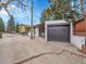 Rear view of a home featuring an attached garage and mature trees at 755 S Milwaukee St, Denver, CO 80209