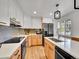 Modern kitchen with white quartz countertops, two-tone cabinetry, stainless steel appliances, and stylish hardware at 755 S Milwaukee St, Denver, CO 80209