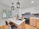 Kitchen featuring an island with a sink, pendant lighting, stainless steel appliances, and lots of cabinet space at 755 S Milwaukee St, Denver, CO 80209