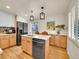 Bright, modern kitchen with a center island, stainless steel appliances, and light wood cabinetry, perfect for cooking at 755 S Milwaukee St, Denver, CO 80209