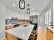Bright kitchen features a large island with a sink, modern appliances, pendant lighting, and lots of cabinet space at 755 S Milwaukee St, Denver, CO 80209