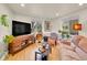 Comfortable living room with hardwood floors, large windows, cozy seating, and modern entertainment setup at 755 S Milwaukee St, Denver, CO 80209