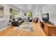 Bright living room with hardwood floors, neutral decor, and plenty of natural light from large windows, creating a cozy space at 755 S Milwaukee St, Denver, CO 80209