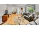 Open living room with hardwood floors, comfortable seating, and a view into the dining area, ideal for modern living at 755 S Milwaukee St, Denver, CO 80209