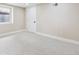 Clean, well-lit basement bedroom with neutral carpet, fresh paint, a single window, and minimalist aesthetic at 2910 Clermont St, Denver, CO 80207