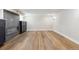 View of the finished basement featuring a modern fireplace, custom cabinets, wood-look floors, and ample space at 2910 Clermont St, Denver, CO 80207