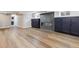Spacious finished basement with wood-look floors, a modern fireplace, and custom cabinets for storage or entertaining at 2910 Clermont St, Denver, CO 80207