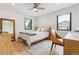 Bright bedroom featuring a neutral color palette, hardwood floors, and many windows at 2910 Clermont St, Denver, CO 80207