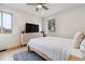 Cozy bedroom with hardwood floors, ceiling fan, and natural light at 2910 Clermont St, Denver, CO 80207