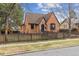 A beautiful brick home with a well-kept lawn and classic design elements at 2910 Clermont St, Denver, CO 80207
