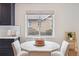 A sunlit dining area with a cozy table next to a large window with views at 2910 Clermont St, Denver, CO 80207