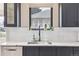 Kitchen sink with view features navy cabinets, white backsplash, and stainless dishwasher at 2910 Clermont St, Denver, CO 80207