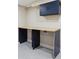 Efficient laundry area with a functional workstation, storage cabinets, and modern geometric flooring at 2910 Clermont St, Denver, CO 80207