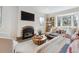 Cozy living room featuring a charming fireplace and a large bay window at 2910 Clermont St, Denver, CO 80207