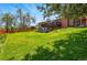 A large backyard is mostly grass, with mature trees and a second-story deck at 11715 W 30Th Pl, Lakewood, CO 80215