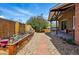 The tranquil backyard offers a garden, stone pathway, privacy fence and mature tree at 11715 W 30Th Pl, Lakewood, CO 80215