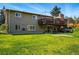 Spacious backyard featuring a lush lawn and a partial view of the house with a wooden fence on the right at 11715 W 30Th Pl, Lakewood, CO 80215