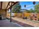 This backyard features a grill, brick oven, a garden, and decorative hanging lights at 11715 W 30Th Pl, Lakewood, CO 80215