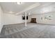 Spacious basement featuring a fireplace, large TV, and neutral color carpet at 11715 W 30Th Pl, Lakewood, CO 80215