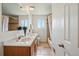 Bathroom featuring a double sink vanity, tile flooring, and a bathtub with shower at 11715 W 30Th Pl, Lakewood, CO 80215