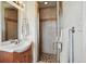 Bathroom featuring a glass enclosed shower and a vanity with granite countertops at 11715 W 30Th Pl, Lakewood, CO 80215