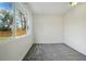 This bright bedroom offers neutral carpeting, white walls and trim, and a large window at 11715 W 30Th Pl, Lakewood, CO 80215