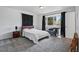 Bedroom with carpet flooring, natural light, neutral tones, and a black chaise lounge at 11715 W 30Th Pl, Lakewood, CO 80215