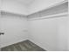 A bright white walk-in closet with neutral carpet and a hanging rod for storage at 11715 W 30Th Pl, Lakewood, CO 80215
